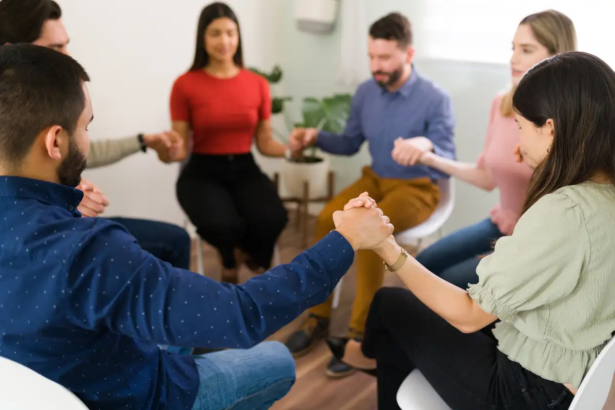 men and women during prayer meeting in Faith-Based Luxury Drug and Alcohol Rehab